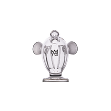 The MJ Arsenal Dubbler Original Double Bubbler is a clear borosilicate glass piece with a stylized figure design, two rounded side features, and a chest crown emblem, shown on a plain white background.
