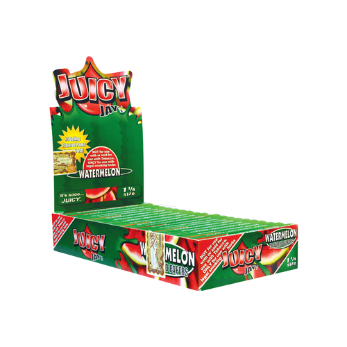 A box of Juicy Jay's Flavored Papers, mostly green with watermelon slice images, contains multiple packs arranged in rows. Each paper uses a triple-dipped system for an extra juicy burst of flavor.