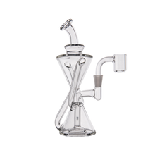 The MJ Arsenal Time Turner Mini Dab Rig is a clear borosilicate glass piece featuring a geometric hourglass-shaped chamber, curved mouthpiece, and side-angled quartz banger, shown against a white background.
