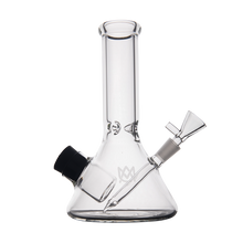 The MJ Arsenal Cache Bong is a clear borosilicate glass beaker-style water pipe with a wide base, straight neck, angled downstem, glass bowl, and black rubber grommet.