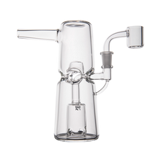 The MJ Arsenal Turret Mini Dab Rig is a portable piece crafted from durable borosilicate glass, featuring a cylindrical base, angled mouthpiece, side arm with quartz banger, and an efficient percolator for smooth hits.