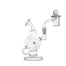 The MJ Arsenal Atlas Mini Dab Rig is crafted from clear borosilicate glass with a round chamber, angled mouthpiece, wide base, quartz banger, small handle, and features the “MW” logo on the chamber.