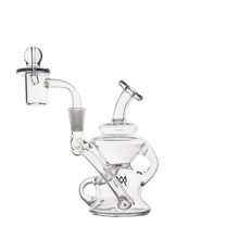 The MJ Arsenal Hydra Mini Dab Rig, featuring a clear glass body, rounded base, angled mouthpiece, side handle, and glass dome attachment, offers a compact and spill-resistant bubbler design against a plain white background.