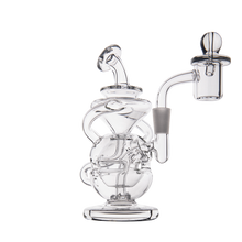 The MJ Arsenal Infinity Mini Dab Rig is a clear borosilicate glass piece with intricate swirling designs, a round base, and an attached handled bowl with dome, shown on a plain white background.