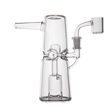 The MJ Arsenal Turret Mini Dab Rig is a sleek, modern piece made from clear borosilicate glass, featuring a cylindrical base, vertical chamber, side mouthpiece, and angled joint—perfectly portable for on-the-go sessions.