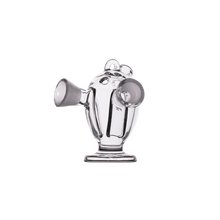 The MJ Arsenal Dubbler Original Double Bubbler is a clear borosilicate glass piece with a cartoonish shape, two round openings as arms, a small rounded base, and two circular ear-like features on top, shown on a plain white background.