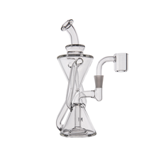 The MJ Arsenal Time Turner Mini Dab Rig is a clear borosilicate glass rig with a scientific geometric design, featuring a triangular chamber, angled mouthpiece, and side arm with quartz banger attachment.