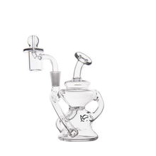 The MJ Arsenal Hydra Mini Dab Rig is a clear, compact bubbler with a round base, curved neck, and side handle. It includes an attached quartz banger and bubble carb cap for spill-resistant, smooth hits—perfect for dabbing on a white background.