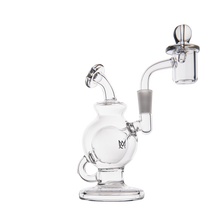 The MJ Arsenal Atlas Mini Dab Rig, made from clear borosilicate glass with a round chamber, angled neck, flat base, and attached quartz banger with carb cap, is shown on a white background—ideal as a compact dab rig.