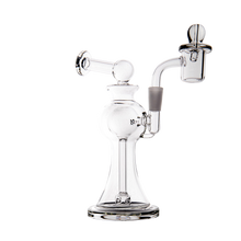 The MJ Arsenal Apollo Mini Dab Rig, made of clear borosilicate glass with a wide base, curved neck, and attached bowl piece, delivers excellent flavor for concentrates or tobacco. Shown on a white background.