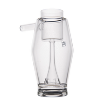 The MJ Arsenal Proxy Bubbler is a clear borosilicate glass pitcher-style piece with a geometric design and an etched M on the front—perfect as a modern, stylish dabbing accessory.