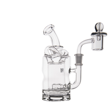 The MJ Arsenal Turbine Mini Dab Rig, made of clear borosilicate glass with a curved mouthpiece, cylindrical chamber, and attached quartz banger, is shown against a white background.