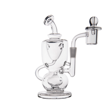 The MJ Arsenal Titan Mini Dab Rig is a clear borosilicate glass rig with a rounded base, curved neck, and attached quartz banger on the right side for vaporizing concentrates. The product is shown against a plain white background.