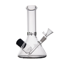The MJ Arsenal Cache Bong features clear borosilicate glass, a beaker-shaped base, cylindrical neck, angled mouthpiece, and removable bowl piece, displayed on a plain white background.