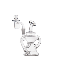 The MJ Arsenal Hydra Mini Dab Rig is a clear glass piece featuring a rounded base, two curved side handles, a circular mouthpiece, and an upright chamber with a banger on top, all shown against a plain white background.