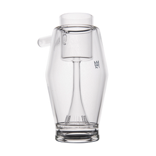 The MJ Arsenal Proxy Bubbler is a clear borosilicate glass vessel with a wide base, narrow neck, angled spout, internal percolator, and a small front logo. Sleek design shown on a plain white background.