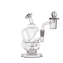 The MJ Arsenal Claude Mini Dab Rig, featuring multiple chambers, a bent neck, and a quartz banger, is displayed against a plain white background.