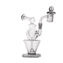 The MJ Arsenal Gemini Mini Dab Rig is a compact borosilicate glass rig with multiple chambers, a curved neck, and a bowl attachment—beautifully showcased against a white background.