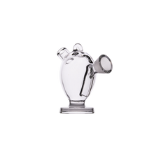 The MJ Arsenal The Martian® Original Blunt Bubbler™ is a clear glass mini watering can-shaped bubbler with round body, spout, handle, and flat base, providing stylish water filtration; shown on a plain white background.