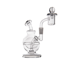 The MJ Arsenal Royale Mini Dab Rig, featuring clear borosilicate glass, a round base, curved neck, and attached quartz banger for concentrates, is displayed against a plain white background.