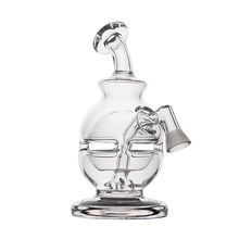The MJ Arsenal Royale Vape Edition is a clear glass dab rig water pipe with a stylized face design featuring closed eyes, a curved mouth, and a rounded base, shown against a white background.