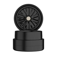 The Flower Mill 2" Next Gen Standard Grinder, a black cylindrical grinder with a textured interior, is shown open with its lid standing upright on the base against a white background.