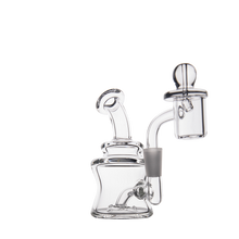 The MJ Arsenal Jammer Mini Dab Rig, made from clear borosilicate glass with a bent neck, round base, and attached quartz banger, is photographed against a plain white background.