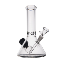 The MJ Arsenal Cache Bong is a clear borosilicate glass piece in classic beaker style, with a wide base, straight neck, angled downstem, and removable bowl, shown against a plain white background.