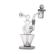 The MJ Arsenal Gemini Mini Dab Rig is a clear borosilicate glass rig with a round chamber, angled neck, percolator, and detachable bowl—compact and portable for smooth dabs anywhere. Shown on a plain white background.