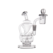 The MJ Arsenal Claude Mini Dab Rig is a clear glass recycler with intricate, twisting tubes and a rounded base for superior filtration, shown against a plain white background.