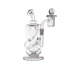 The MJ Arsenal Titan Mini Dab Rig, made from clear borosilicate glass with intricate curves, a wide base, bent neck, and side-mounted quartz banger attachment, is shown against a white background.