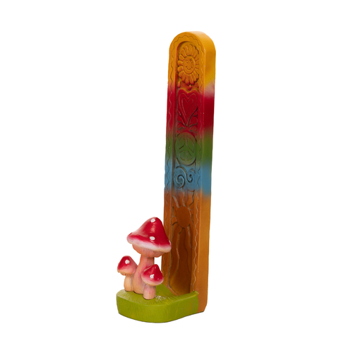 The Fantasy Tower Incense Burners are hand-painted resin holders with a trio of red mushrooms at the base and a carved, decorative back featuring assorted floral and sun designs in vibrant colors.