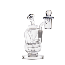 The MJ Arsenal Claude Mini Dab Rig features clear glass with a cylindrical base, angled mouthpiece, attached bowl for concentrates, and a transparent design that highlights its scientific recycler shape.