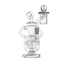 The MJ Arsenal Infinity Mini Dab Rig, made from clear borosilicate glass, features a round base, angled mouthpiece, and attached quartz banger with carb cap, shown on a white background.