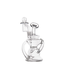 The MJ Arsenal Hydra Mini Dab Rig is a clear glass recycler with a unique, curvy design, multiple chambers, a cylindrical mouthpiece, and a bowl attachment, shown against a plain white background.