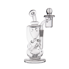 The MJ Arsenal Titan Mini Dab Rig, made of clear borosilicate glass with curved chambers and a side bowl attachment, is designed for smoking or vaporizing and is displayed against a plain white background.