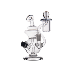 The MJ Arsenal Mini Jig Mini Dab Rig features multiple chambers, a bent neck, domed carb cap, attached downstem, and built-in storage jar, shown against a plain white background.