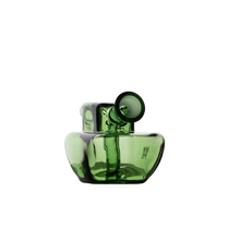 The MJ Arsenal Commander Blunt Bubbler is a modern green borosilicate glass piece with a unique abstract shape, featuring a wide base, narrow neck, and angled cylindrical spout, shown on a plain white background.
