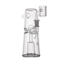 The MJ Arsenal Turret Mini Dab Rig is a clear borosilicate glass dab rig with intricate internal percolators, a cylindrical base, angled mouthpiece, and side-mounted bowl attachment, shown on a plain white background.