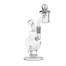 The MJ Arsenal Atlas Mini Dab Rig, made of clear borosilicate glass, features a curved bulbous base, straight neck, and an attached quartz banger with carb cap. This compact rig is shown against a white background.