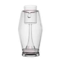 The MJ Arsenal Proxy Bubbler, crafted from clear borosilicate glass with a sleek, modern look, features an integrated wine glass-shaped chamber and is shown on a white background—an elegant piece inspired by high-end dabbing accessories.