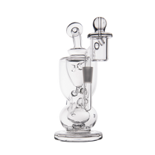 The MJ Arsenal Titan Mini Dab Rig features clear borosilicate glass, multiple chambers, a round base, vertical neck, and a side attachment for your bowl or nail. Its modern scientific design is ideal for smoking or vaporizing concentrates.