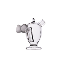 The MJ Arsenal Dubbler Original Double Bubbler features clear borosilicate glass with a round base, cylindrical neck, angled spout, and handle-like extensions—perfect for smooth water filtration. Photographed against a plain white background.