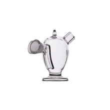 The MJ Arsenal Dubbler Original Double Bubbler features clear borosilicate glass, a wide base, cylindrical body, angled mouthpiece, and circular side opening; shown on a white background.