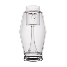 The MJ Arsenal Proxy Bubbler is a clear borosilicate glass carafe with a modern, geometric design featuring an inner cylindrical tube and a faceted outer shape inspired by stylish dabbing accessories.