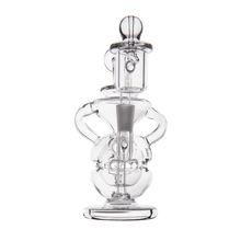 The MJ Arsenal Infinity Mini Dab Rig is a clear borosilicate glass piece with a fab egg percolator, multiple chambers, curved handles, and a rounded base, displayed against a plain white background.
