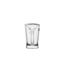 The MJ Arsenal Basin Bubbler is a clear borosilicate glass shot glass featuring an intricate inner design inspired by a mini bubbler, displayed on a plain white background.