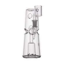 The MJ Arsenal Turret Mini Dab Rig, made from borosilicate glass, features a cylindrical base, vertical neck, quartz banger, and visible percolators and joints, all shown against a plain white background.