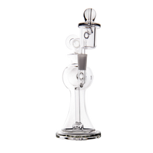 The MJ Arsenal Apollo Mini Dab Rig is a clear borosilicate glass water pipe with a wide base, cylindrical neck, attached bowl, and carb cap—designed for flavor preservation—shown against a plain white background.
