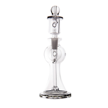The MJ Arsenal Apollo Mini Dab Rig, made of clear borosilicate glass with a round base and straight neck for enhanced flavor preservation, is shown against a plain white background.